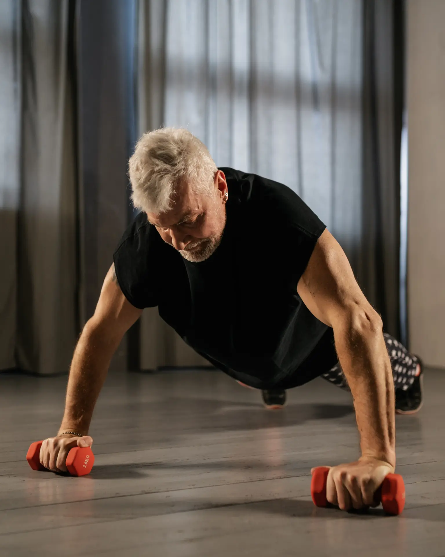 Man performing a strength workout with dumbbells